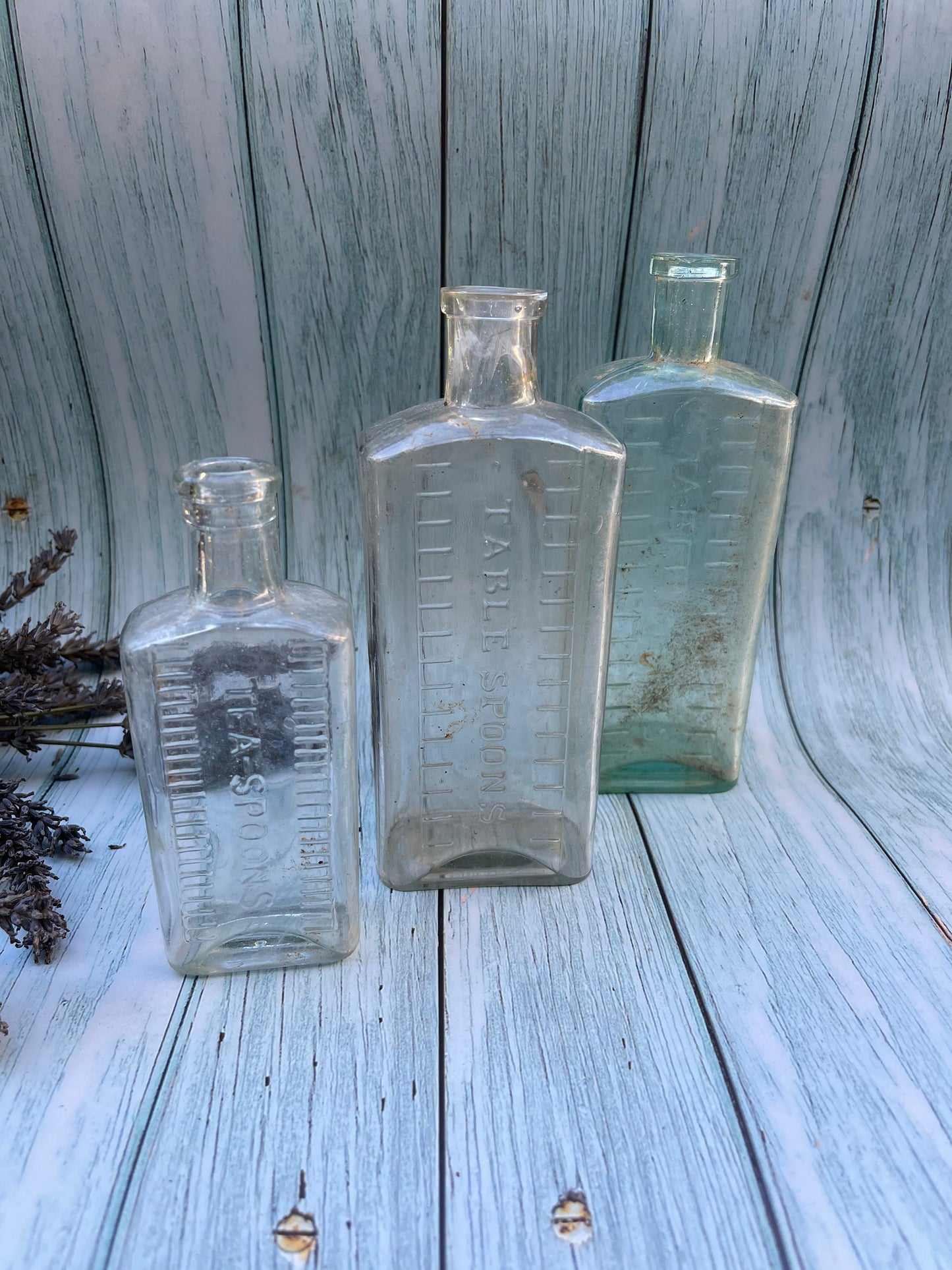 Three Vintage Clear Medicine Bottles with Teaspoon and Tablespoon Measures